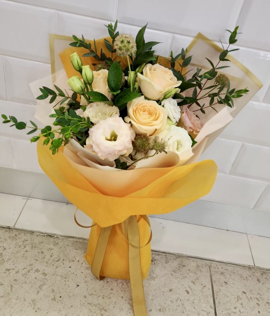 Lovely champagne roses with seasonal fillers and foliages | Online ...